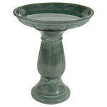 Green ceramic bird bath on a white background
